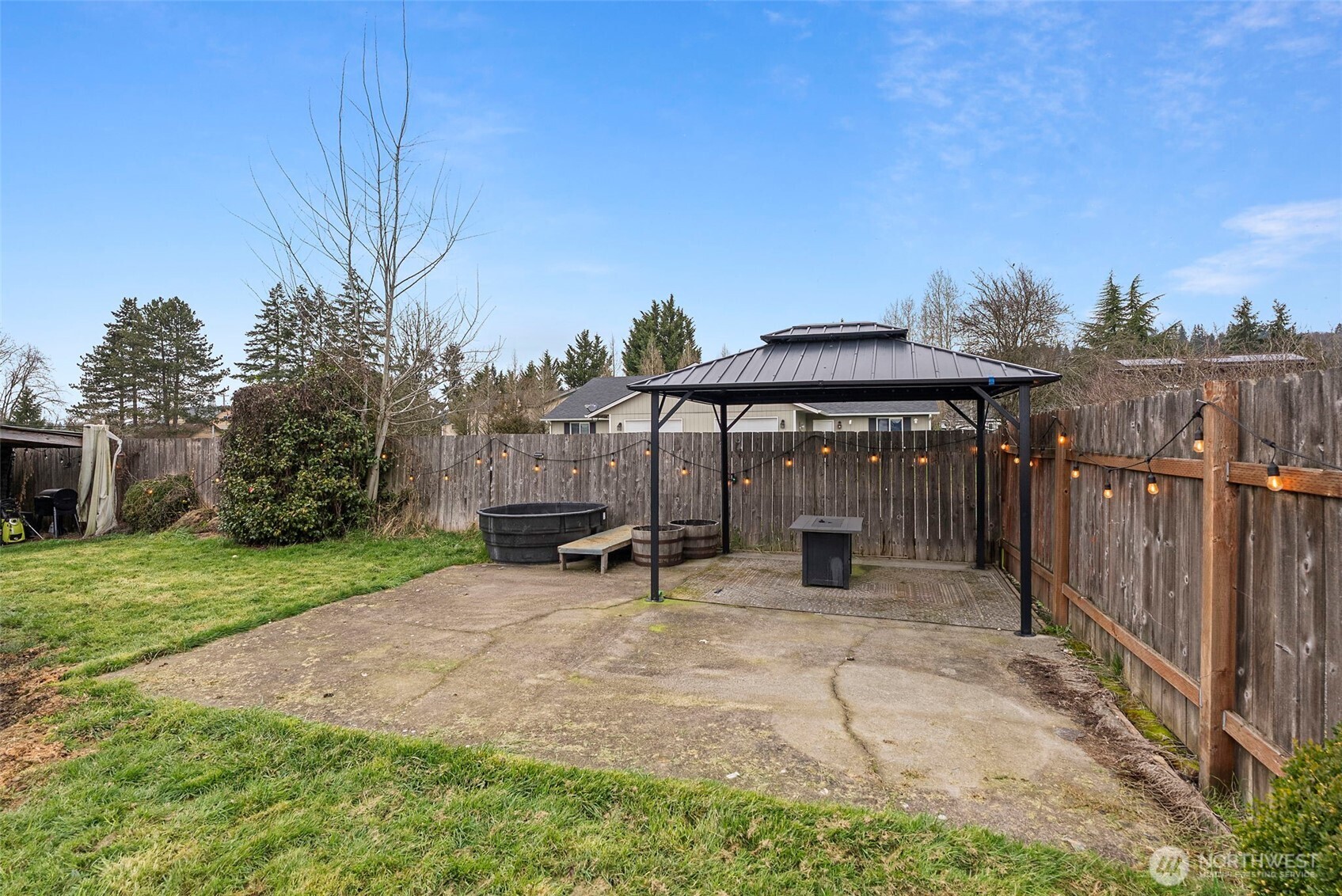 2046 Southwest Salsbury Avenue Chehalis, WA 98532 - Photo 31 of 36 a view of a patio with a table and chairs under an umbrella with wooden fence