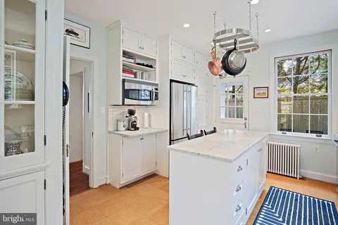 a very nice looking room with a large window and a kitchen