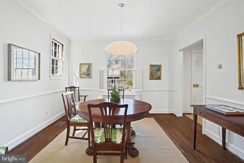 a view of a a dining room with furniture window and wooden floor
