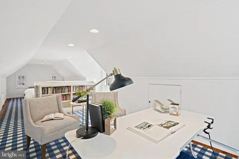 a living room with furniture and white walls