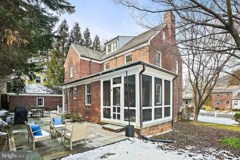 a view of a house with a yard and sitting area