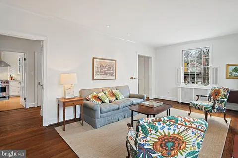 a living room with furniture a rug and a window