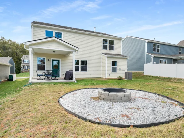 a view of a house with swimming pool and a yard
