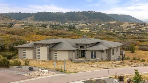 a view of a house with a mountain yard in front of it