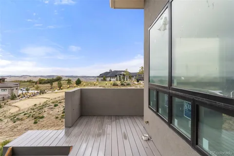 a view of a balcony with wooden floor