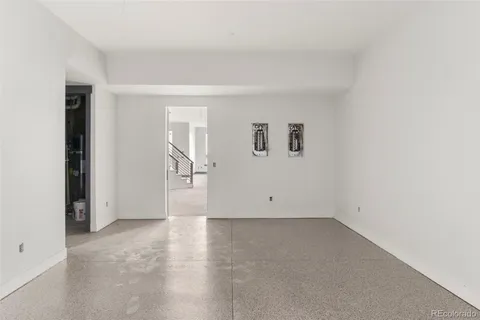 an empty room with a empty space and windows