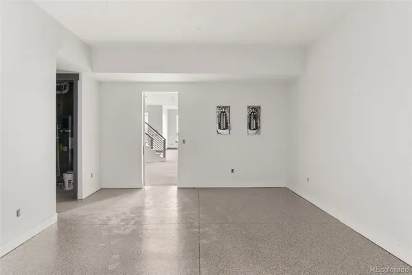 an empty room with a empty space and windows