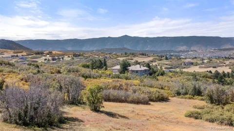 a view of a mountain range with a forest