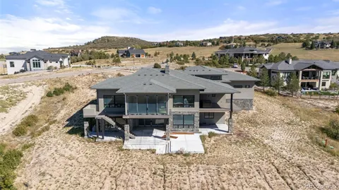 a view of a terrace with a table and chairs under an umbrella
