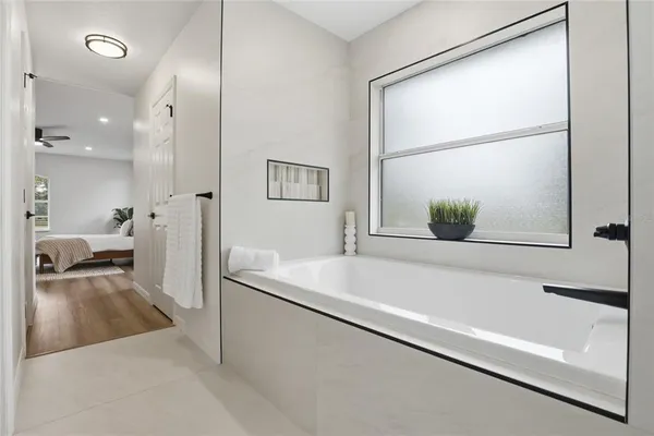 a bathroom with a tub and a shower