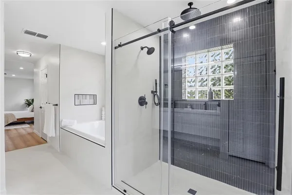 a bathroom with a shower and a tub