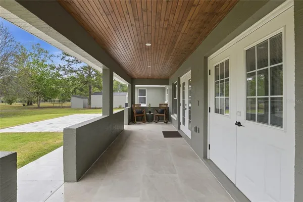 a view of a backyard with a garden and entertaining space