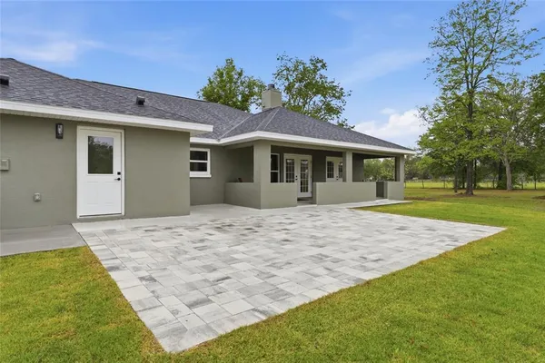 an aerial view of a house with swimming pool outdoor seating and yard