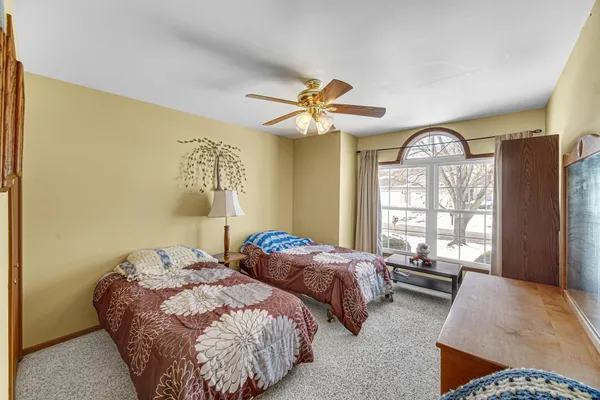 a bedroom with two beds and a large window