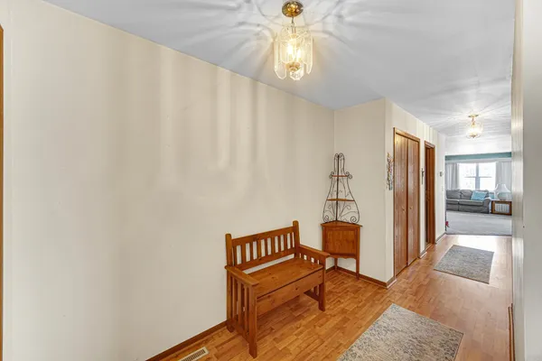 a living room with furniture and a chandelier