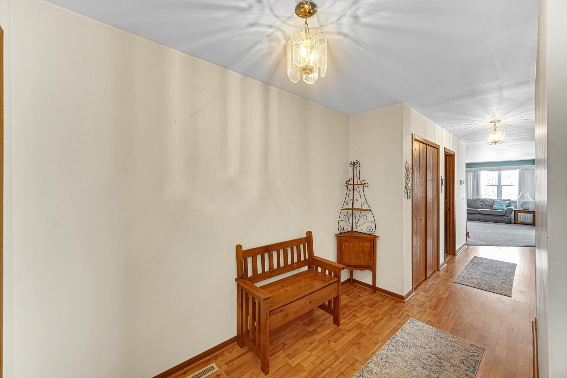 8613 Van Buren Street Merrillville, IN 46410 - Photo 2 of 18 a living room with furniture and a chandelier