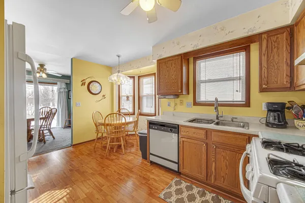 a kitchen with stainless steel appliances granite countertop a sink stove and cabinets