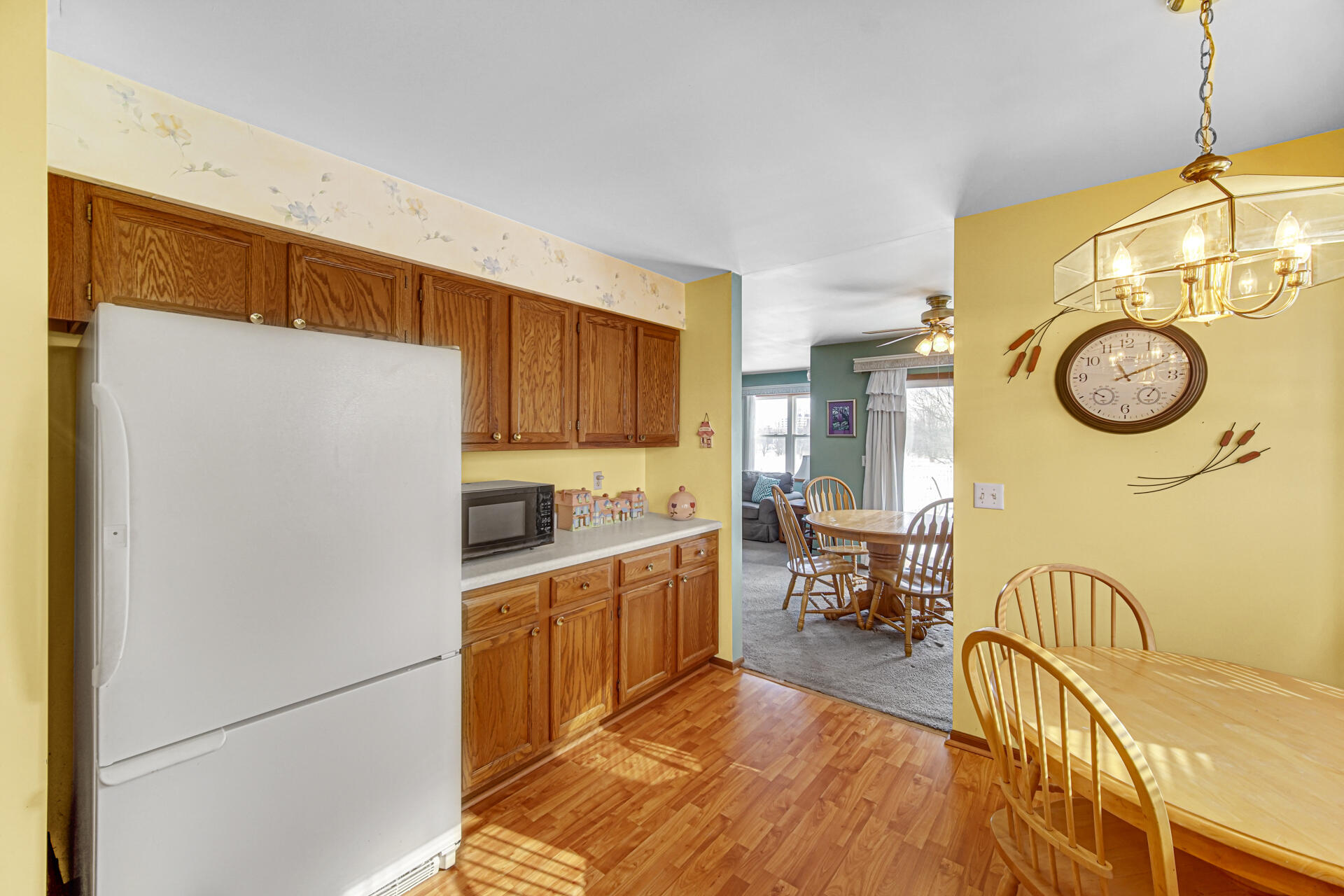8613 Van Buren Street Merrillville, IN 46410 - Photo 7 of 18 a kitchen with stainless steel appliances granite countertop a refrigerator a stove and a sink with wooden floor
