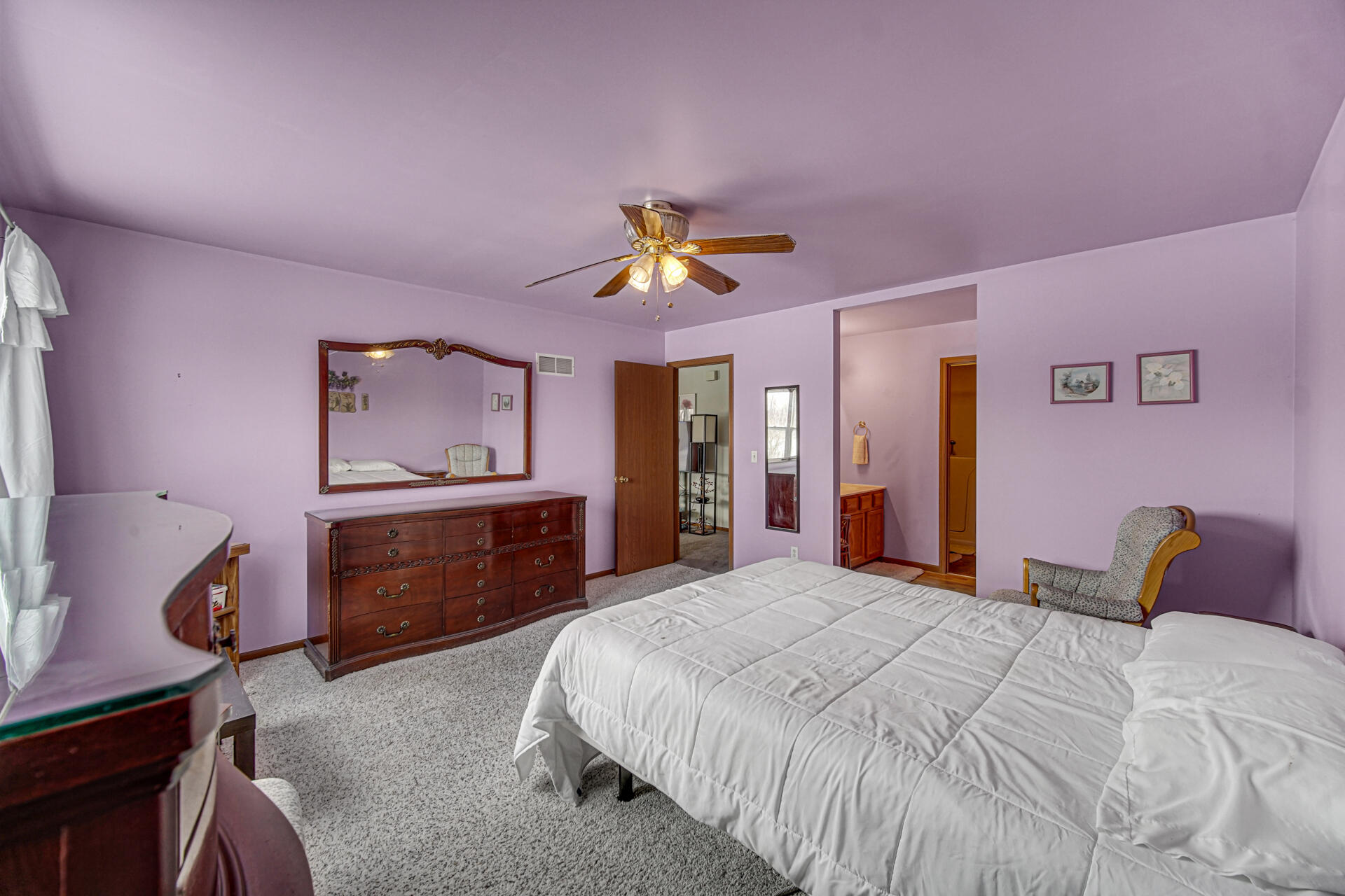 8613 Van Buren Street Merrillville, IN 46410 - Photo 9 of 18 a bedroom with a bed and a chandelier