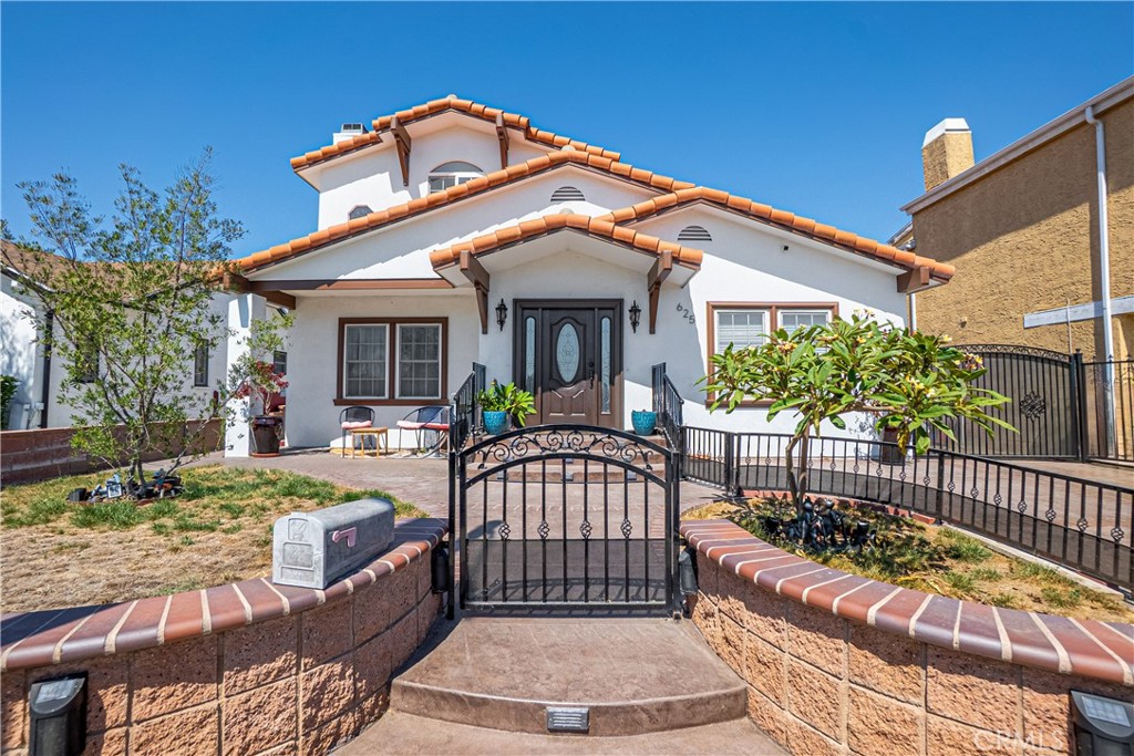 a front view of a house with garden