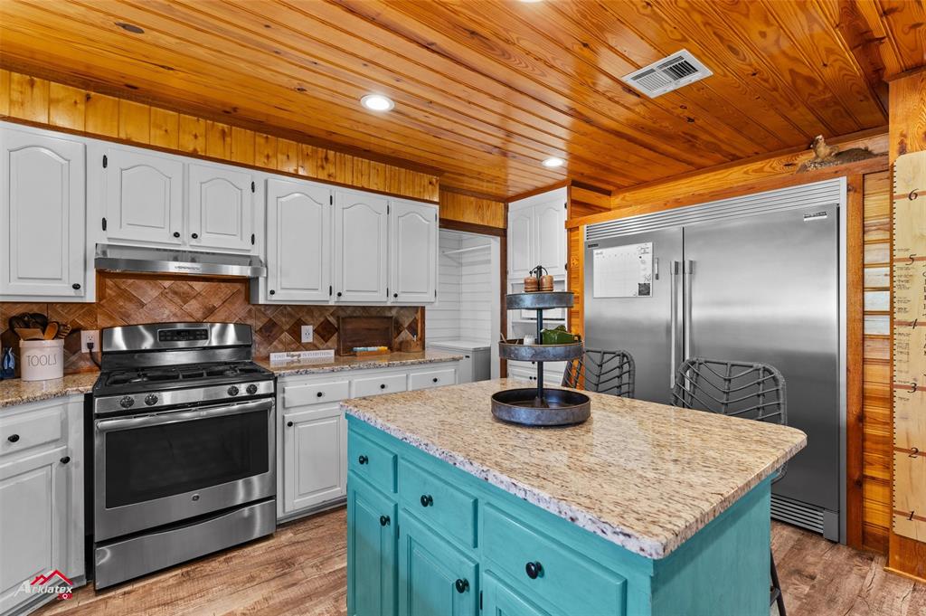 10073 Ferry Lake Road Oil City, LA 71061 - Photo 11 of 39 a kitchen with granite countertop a sink a stove and cabinets