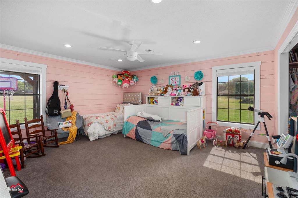 10073 Ferry Lake Road Oil City, LA 71061 - Photo 21 of 39 a bedroom with furniture a flat tv screen and a window