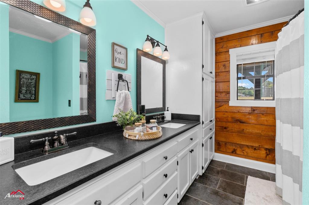 10073 Ferry Lake Road Oil City, LA 71061 - Photo 22 of 39 a bathroom with a sink and a mirror