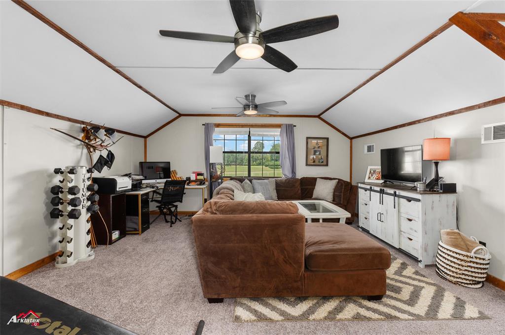 10073 Ferry Lake Road Oil City, LA 71061 - Photo 26 of 39 a living room with furniture a flat screen tv and a large window