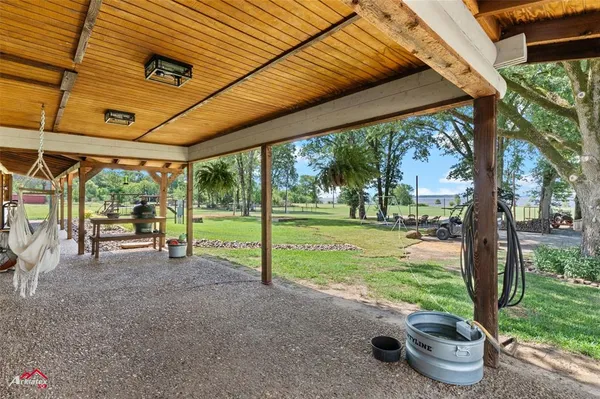 a view of a patio with table and chairs next to a yard