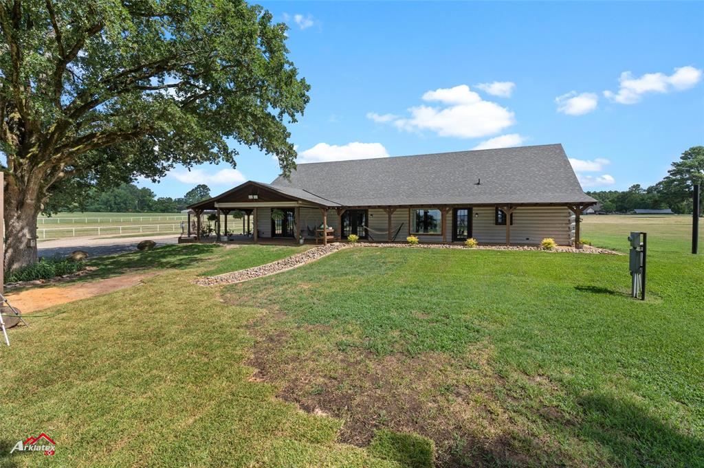 10073 Ferry Lake Road Oil City, LA 71061 - Photo 29 of 39 a front view of a house with garden