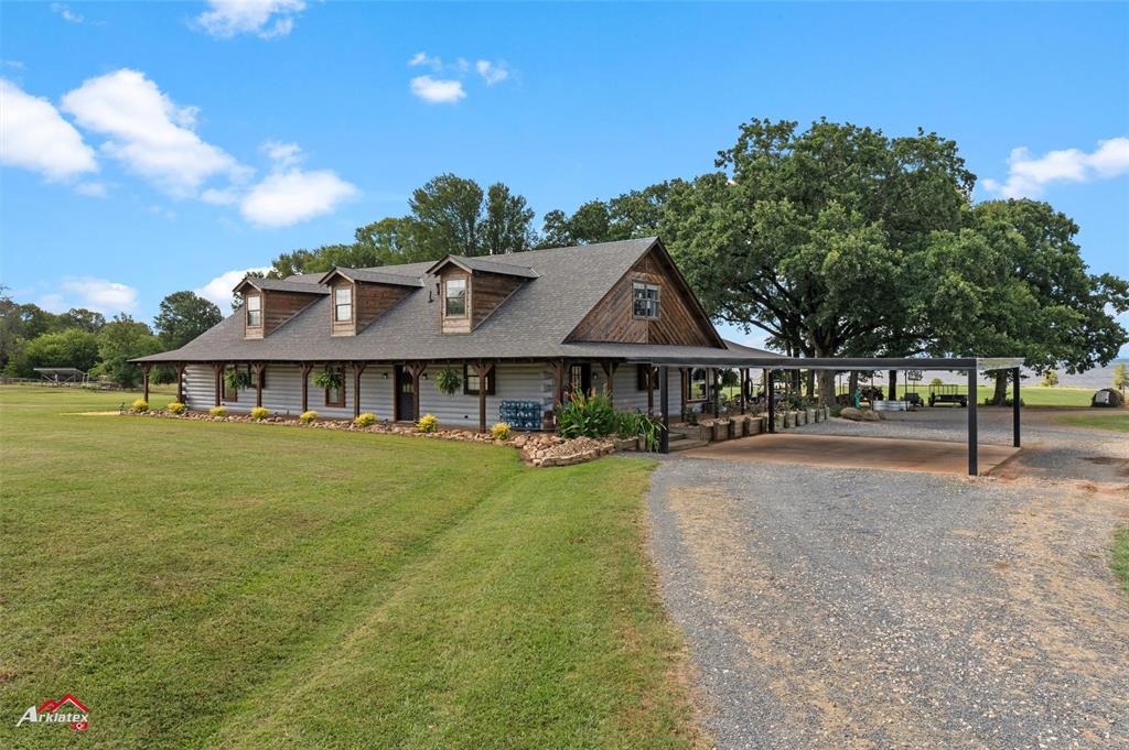 10073 Ferry Lake Road Oil City, LA 71061 - Photo 4 of 39 a front view of a house with garden