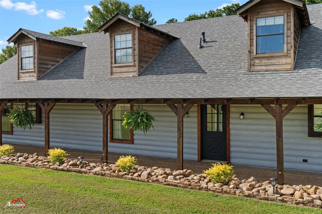 10073 Ferry Lake Road Oil City, LA 71061 - Photo 5 of 39 a front view of house with a garden