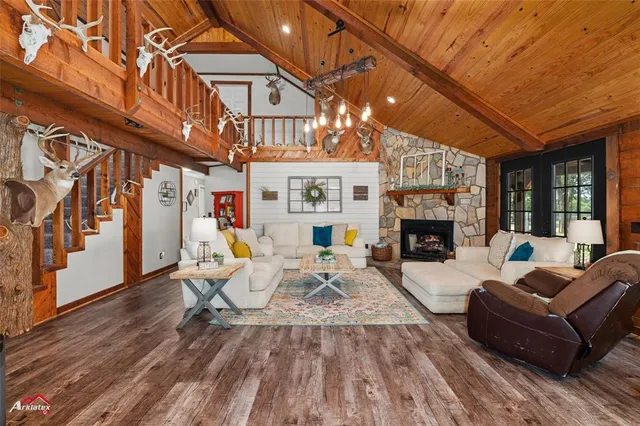 a living room with furniture a fireplace and a large window