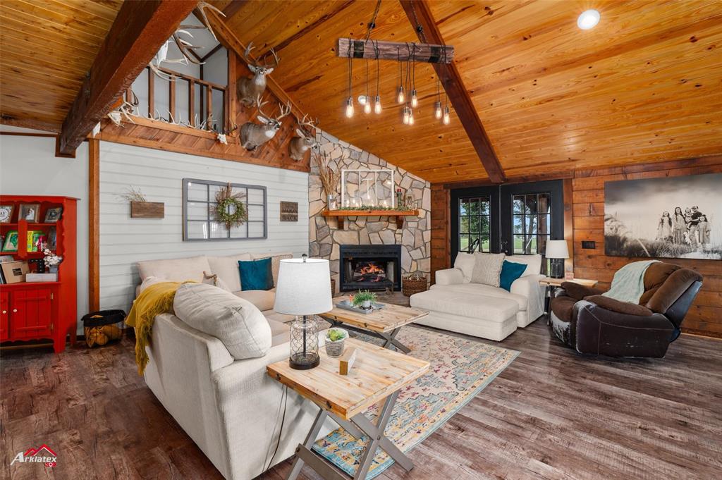 10073 Ferry Lake Road Oil City, LA 71061 - Photo 7 of 39 a living room with furniture a fireplace and a large window