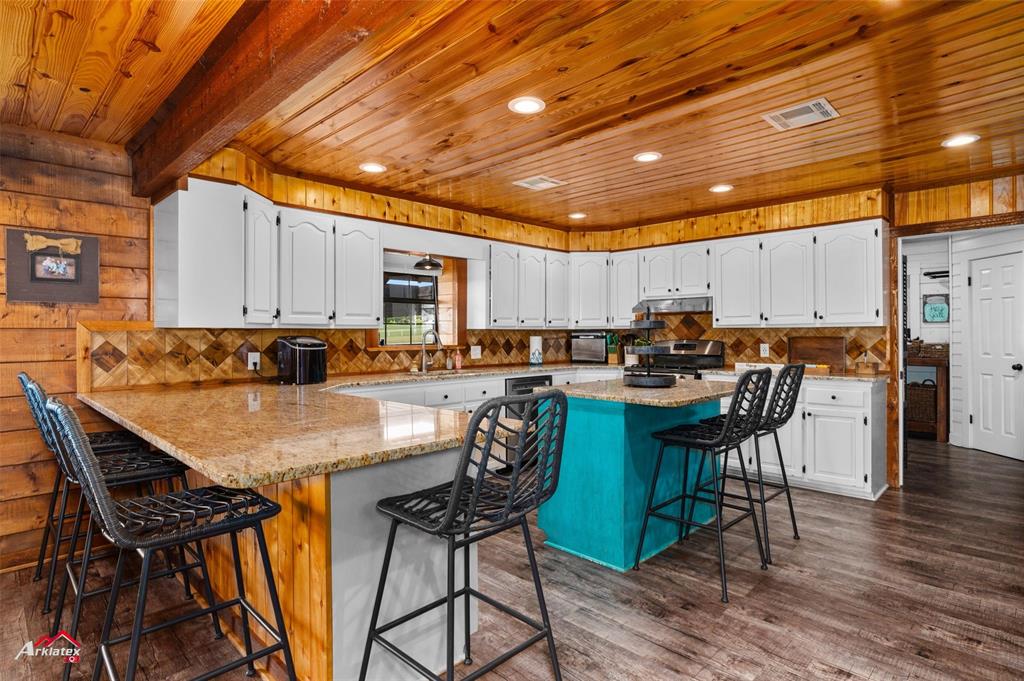 10073 Ferry Lake Road Oil City, LA 71061 - Photo 10 of 39 a kitchen with a table chairs stove and cabinets