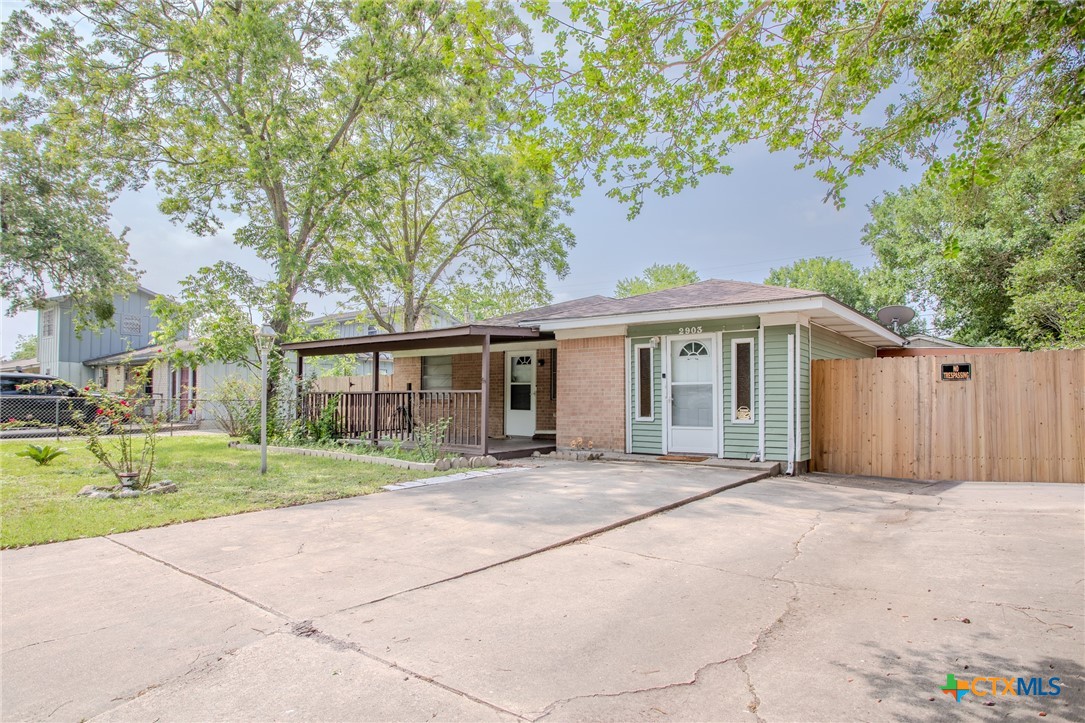 2903 Gayle Street Victoria, TX 77901 - Photo 2 of 21 a front view of a house with a yard and trees