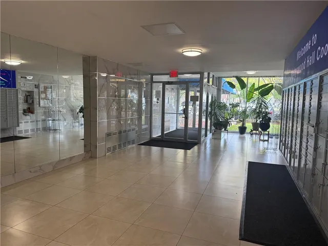 a lobby with furniture and a potted plant