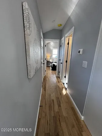 a view of a hallway with wooden floor