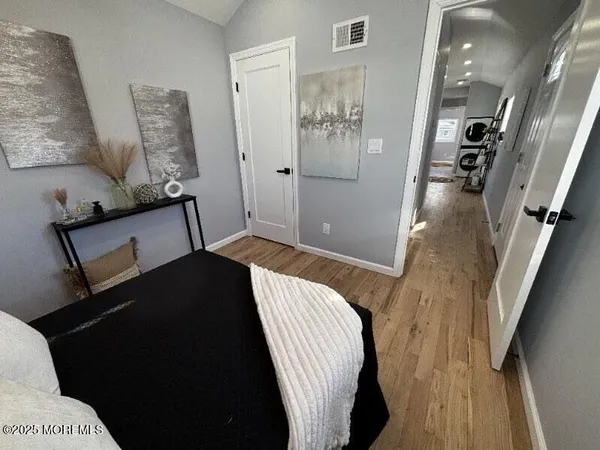 a bedroom with a bed and a painting on the wall