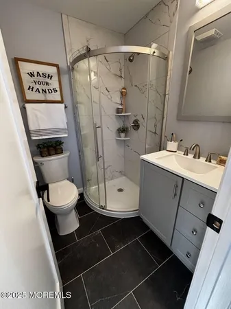 a bathroom with a toilet a sink and shower