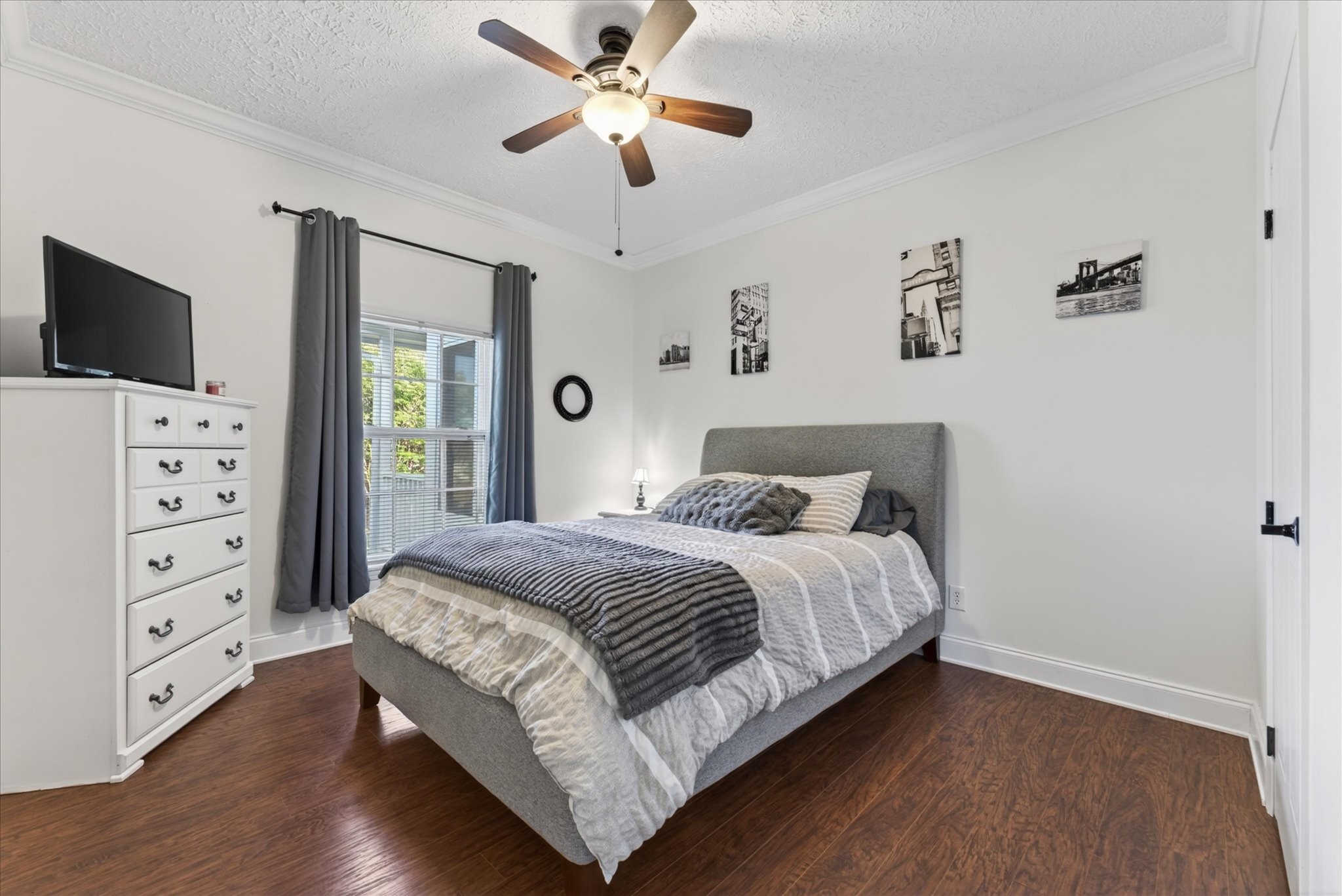 2108 Buckskin Court Spring Hill, TN 37174 - Photo 22 of 39 a bedroom with a large bed and a flat tv screen on dresser