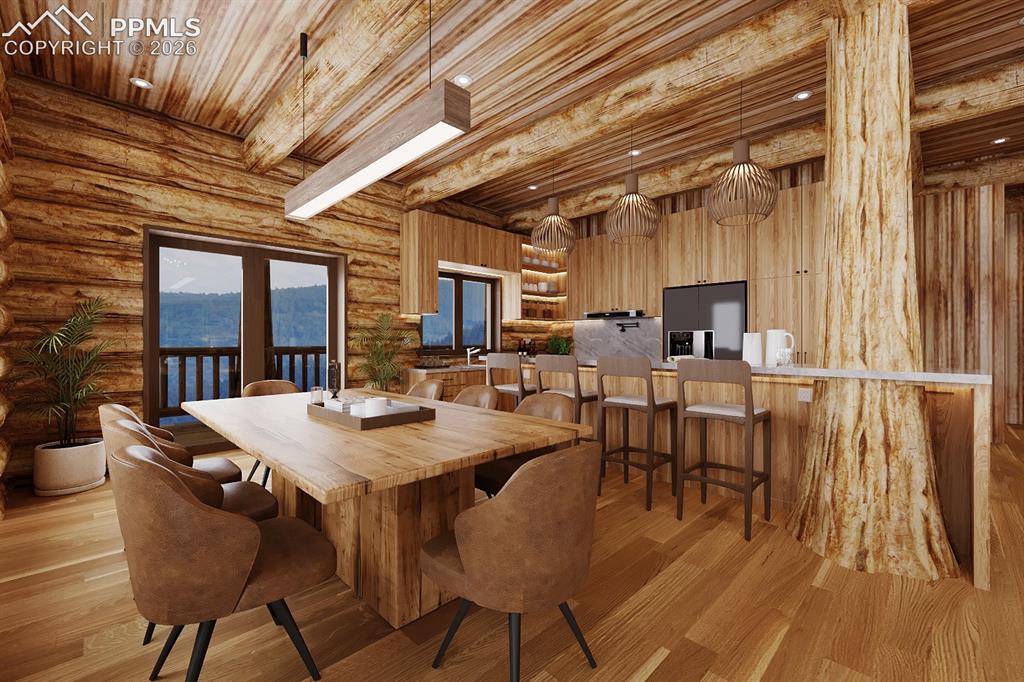 9297 Chipita Park Road Cascade, CO 80809 - Photo 9 of 25 a view of a dining room with furniture window and wooden floor