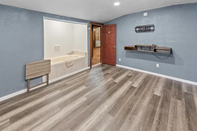 a spacious bedroom with a bed and a desk