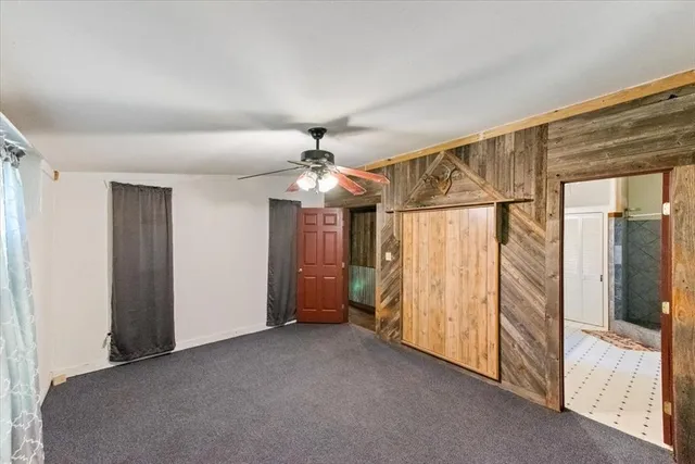 a view of a room with a ceiling fan