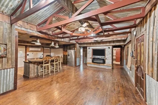 a view of large room with wooden floor and windows