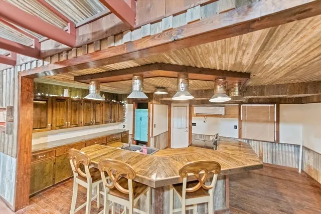 a dinning table with chairs and table in wooden floor