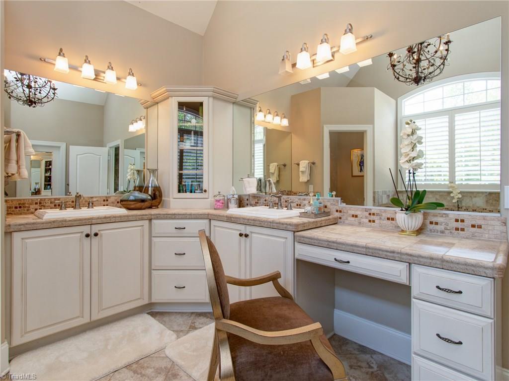 8404 Oakchester Court Oak Ridge, NC 27310 - Photo 11 of 30 Dual vanities with knee space and tumbled tile countertop.