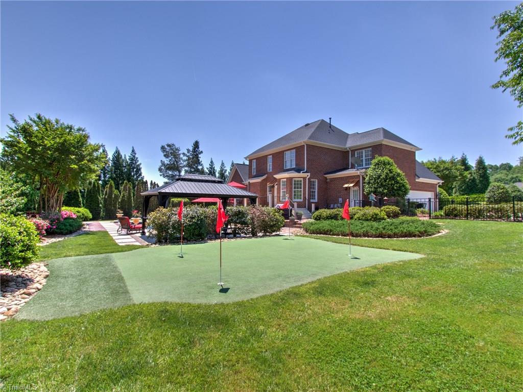 8404 Oakchester Court Oak Ridge, NC 27310 - Photo 25 of 30 Amazing backyard with putting green, gazebo and deck overlooking the beautiful pool.