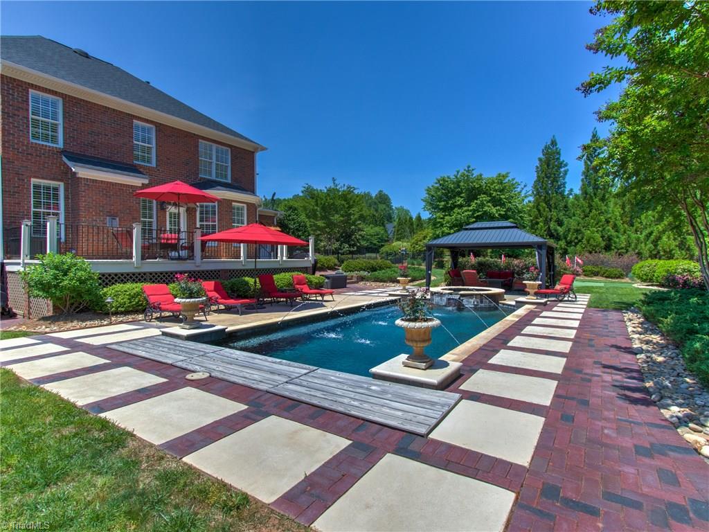 8404 Oakchester Court Oak Ridge, NC 27310 - Photo 26 of 30 Custom built salt water pool with spa, spillway from the spa with remote fountains and gas heater, self-cleaning pool sweep, automatic pool cover.