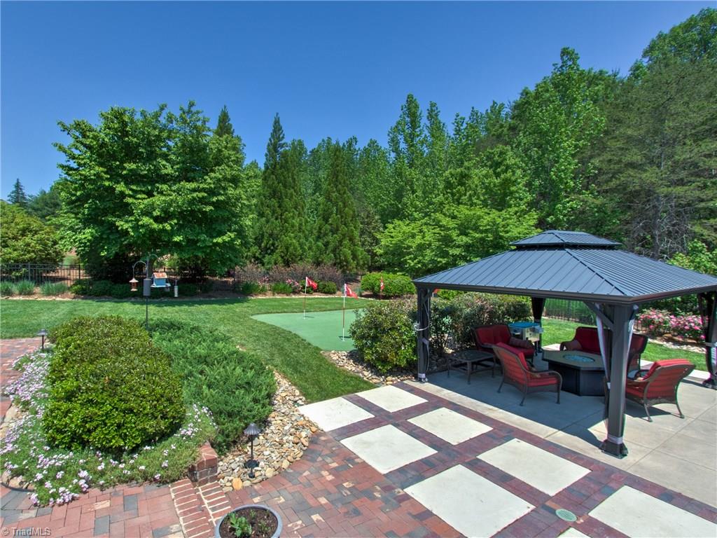 8404 Oakchester Court Oak Ridge, NC 27310 - Photo 28 of 30 View from deck to the beautiful garden with gazebo and putting green.